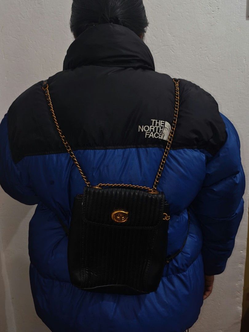 Coach Quilted Leather Backpack Black Gold Hardware (Category: Backpacks) located in Baguio. Submitted by solo_ukay (Listing ID 1467777571, Image 3). Description: - Authentic Coach black quilted leather backpack - Elegant gold-tone hardware with classic turnlock closure - Versatile wear with chain shoulder straps and adjustable leather back straps - Convenient exterior zipper pocket on the back - Beautiful deep maroon interior lining complete with