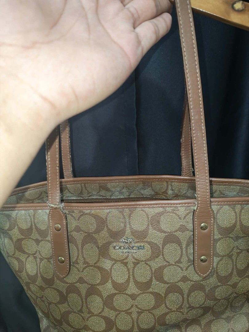 Coach Signature Brown Monogram Tote Bag (Category: Luxury Bags & Wallets) located in Baguio. Submitted by solo_ukay (Listing ID 1467778107, Image 3). Description: - Authentic Coach Signature Monogram Tote Bag (Style F58292) - Classic brown canvas exterior with gold-tone Coach logo lettering - Dual leather shoulder straps with stylish hardware details - Brown fabric-lined interior featuring a convenient zip pocket and Coach storypatch - Condition: