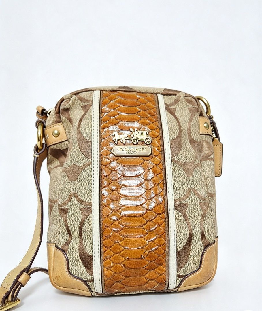 Coach Signature Canvas Crossbody Bag with Python Print (Category: Cross-body Bags) located in Manila. Submitted by jialyn03310_tree (Listing ID 1467835818, Image 1). Description: - Authentic Coach crossbody bag - Signature canvas with brown python embossed leather center panel - Gold-tone horse and carriage logo plaque - Tan leather trim on bottom corners and adjustable shoulder strap - Secure top zip closure - Accented with contrasting white str