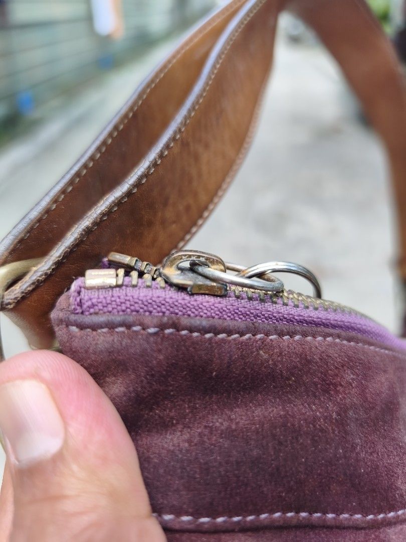 Coach Suede and Leather Shoulder Bag (Category: Luxury Bags & Wallets) located in Bulacan. Submitted by THA_D_THRIFT (Listing ID 1467772286, Image 3). Description: - Brand: Coach - Material: Plum suede with tan leather strap and trim - Closure: Top zip closure - Details: Includes hanging Vegas charm on side ring and leather pull on interior zipper pocket - Interior: Signature Coach C fabric lining with some visible ink stains - Authenticity: Cree
