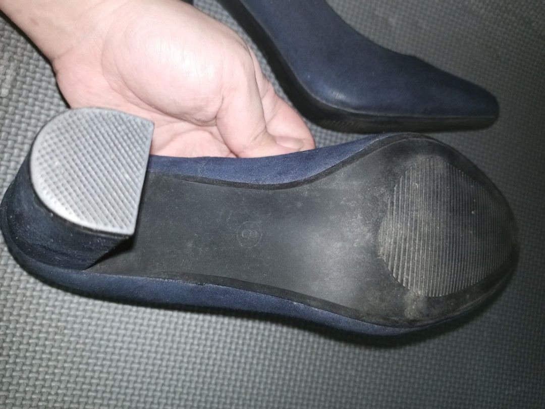 Comfort Plus Navy Blue Block Heel Pumps Size 8 (Category: Heels) located in Manila. Submitted by ettenaej28 (Listing ID 1467714350, Image 3). Description: Comfort Plus block heel pumps in dark navy blue. Size 8 indicated on inner sole and bottom outsole. Chunky block heel style for stable walking. Suede-like material finish. Cushioned inner sole with visible wear patterns on the padding. Bottom soles show moderate usage scuffs..