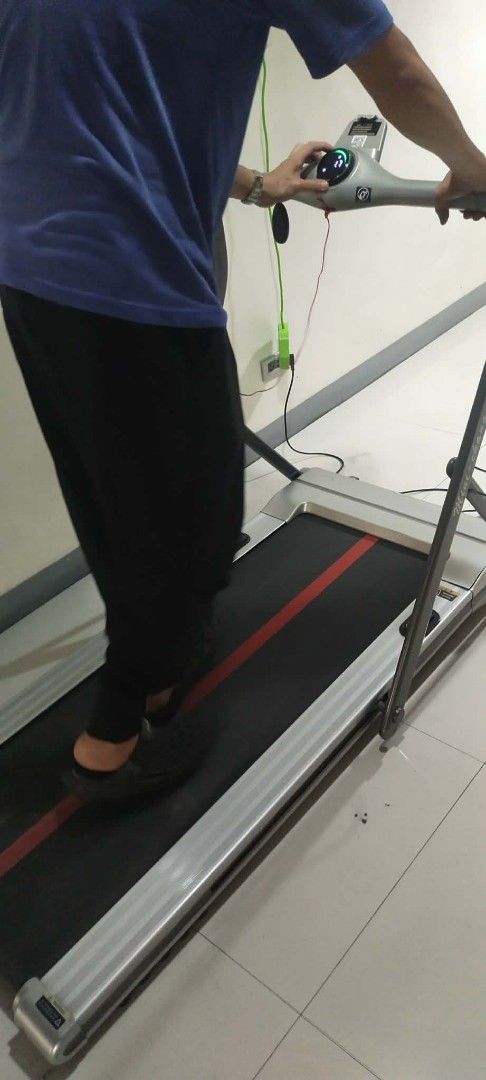 Compact Electric Treadmill with Digital Display (Category: Cardio & Fitness Machines) located in Manila. Submitted by yorkie112643153 (Listing ID 1467654812, Image 2). Description: Working po ito nakatambak lang BINONDO MANILA - Electric treadmill with a clear digital display for workout metrics - Compact footprint, perfect for home workouts and small spaces - Sleek silver frame with a black running belt, red center stripe, and branding - Include