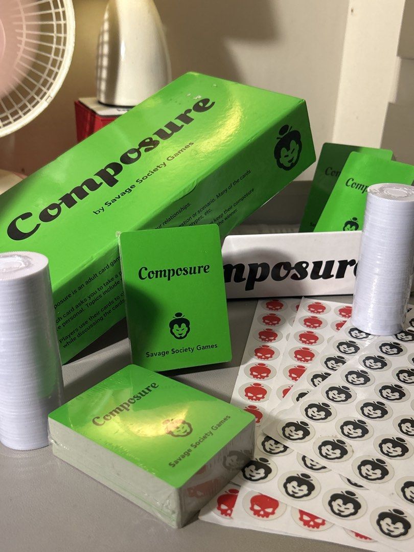Composure Board Game by Savage Society Games (Category: Board Games & Puzzles) located in Santa Rosa. Submitted by sailorplatinum143 (Listing ID 1467794372, Image 2). Description: - Game: Composure party game by Savage Society Games - Condition: Complete set, cards still sealed in plastic - Inclusions: Green outer box, card decks, rolls of blank paper/tokens, and skull/monkey sticker sheets - Vibe: Fun adult card game to test friendships and comp