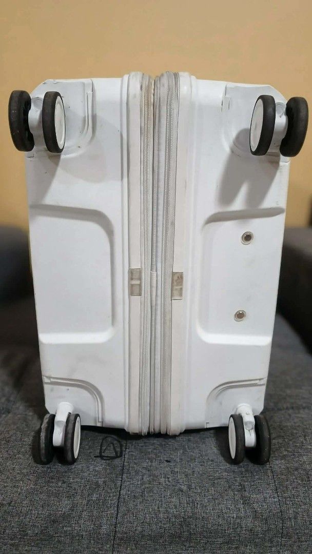 Conwood White Spinner Luggage (Category: Luggage) located in Quezon City. Submitted by mavi14 (Listing ID 1467724825, Image 3). Description: - Brand: Conwood - Color: White - Type: Hardside suitcase - Wheels: Smooth double spinner wheels - Security: Built-in side TSA combination lock - Handles: Convenient top and side grab handles - Condition: Outer shell has normal surface scuffs and zippers show some dirt from travel - Interior: Spacious capaci