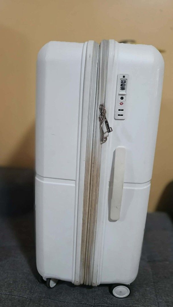 Conwood White Spinner Luggage (Category: Luggage) located in Quezon City. Submitted by mavi14 (Listing ID 1467724825, Image 2). Description: - Brand: Conwood - Color: White - Type: Hardside suitcase - Wheels: Smooth double spinner wheels - Security: Built-in side TSA combination lock - Handles: Convenient top and side grab handles - Condition: Outer shell has normal surface scuffs and zippers show some dirt from travel - Interior: Spacious capaci