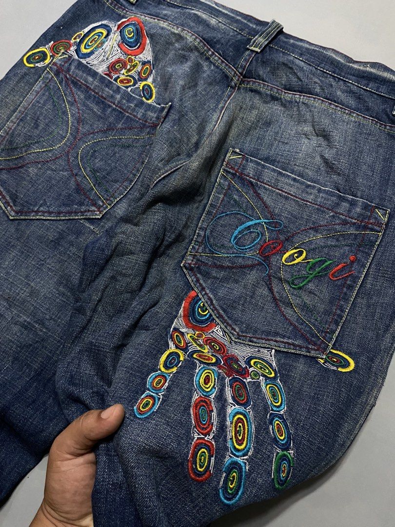 Coogi Embroidered Hand Jeans Denim Pants (Category: Jeans) located in Manila. Submitted by delunakenn94368 (Listing ID 1467757426, Image 3). Description: - Brand/Style: Vintage Coogi dark blue denim jeans with a relaxed Y2K streetwear fit - Details: Heavy colorful embroidery on back pockets and legs, including hand graphics and geometric patterns - Branding: Iconic script Coogi logo embroidered on the pocket - Condition: Natural hem fraying and d
