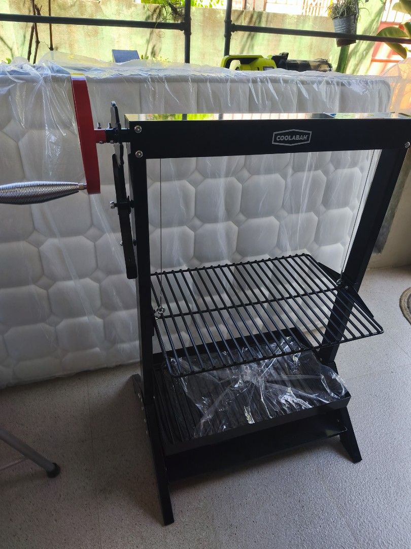 Coolabah Adjustable Height Charcoal BBQ Grill (Category: BBQ, Grills & Hotpots) located in Tarlac. Submitted by ibrahimharb81 (Listing ID 1467744388, Image 3). Description: - Brand: Coolabah Charcoal Grill - Color: Black - Condition: Brand new, never fired up, zero smoke damage (plastic wrap still on lower parts) - Features: Side crank handle for easy cooking grate height adjustment - Build: Sturdy metal frame that stands firmly on legs - Ideal f