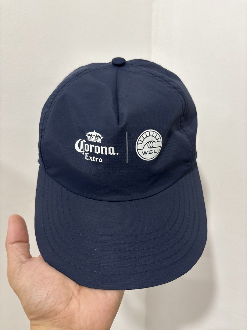 Corona Extra x WSL Navy Blue Cap (Category: Caps & Hats) located in Marikina City. Submitted by zaxcheus_castillo1708 (Listing ID 1467673152, Image 1). Description: - Official Corona Extra x WSL collaboration baseball cap in dark blue - Features crisp white embroidered logos on the front panel - Made from 100% lightweight and breathable polyester - Adjustable strap closure for a customizable fit - Clean interior lining with taped seams for added 