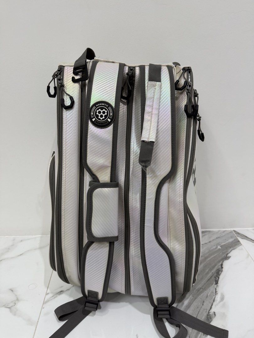 CRBN Pickleball Bag White Backpack (Category: Other Sports Equipment and Supplies) located in Valenzuela. Submitted by alyssa_3 (Listing ID 1467748495, Image 2). Description: - Brand: CRBN Pickleball Backpack - Color: Eye-catching white iridescent material - Storage: Large main compartment, side mesh pockets, plenty of space for multiple paddles and gear - Comfort: Padded shoulder straps with a magnetic closure detail - Condition: Clean interior 