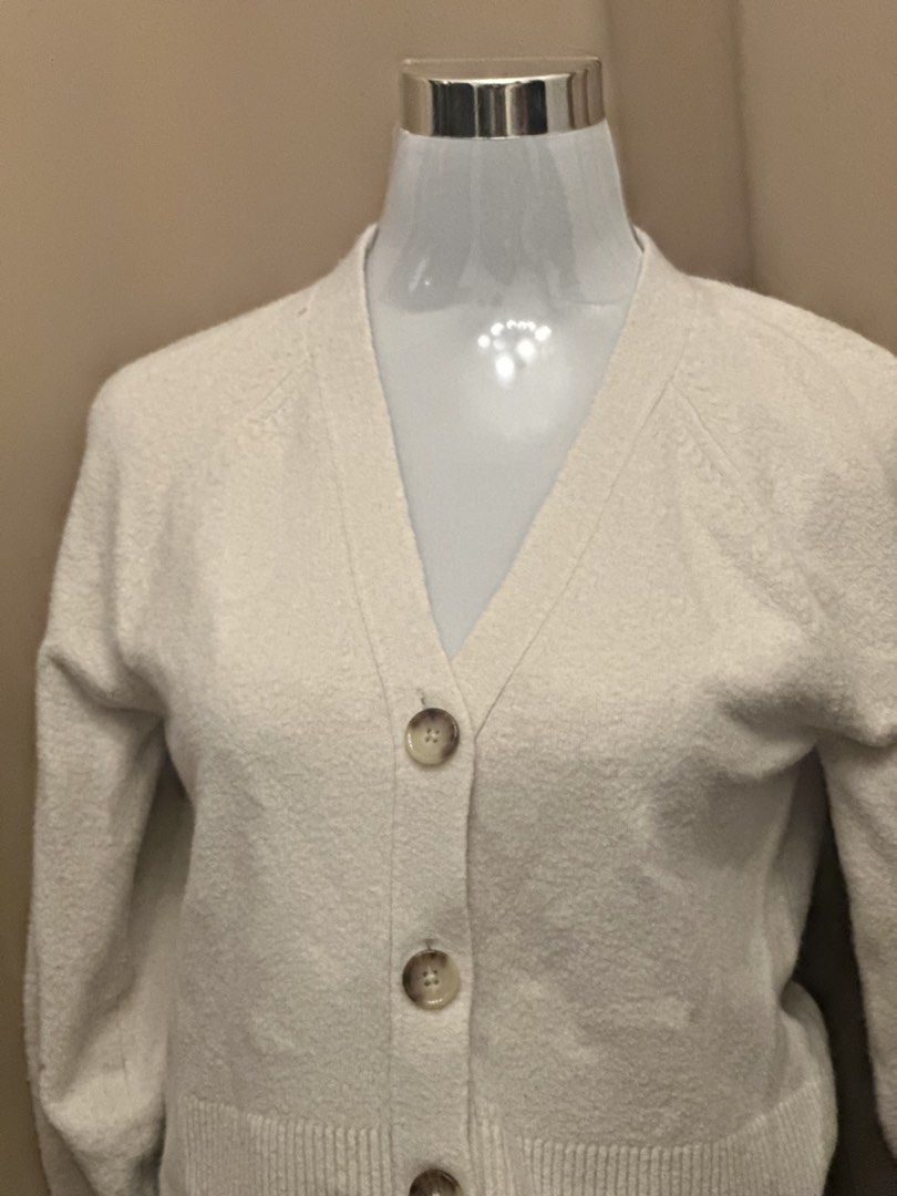 Cream Knit V-Neck Cardigan (Category: Coats, Jackets and Outerwear) located in Manila. Submitted by jade_preloved19 (Listing ID 1467673481, Image 2). Description: - Brand: Uniqlo - Color: Cream - Style: V-neck knit cardigan with button-front closure - Size: S (EU 36 / UK 8 / US 4) - Condition: Excellent pre-owned condition - Features: Soft knit fabric, ribbed hem and cuffs, tortoiseshell-style buttons.