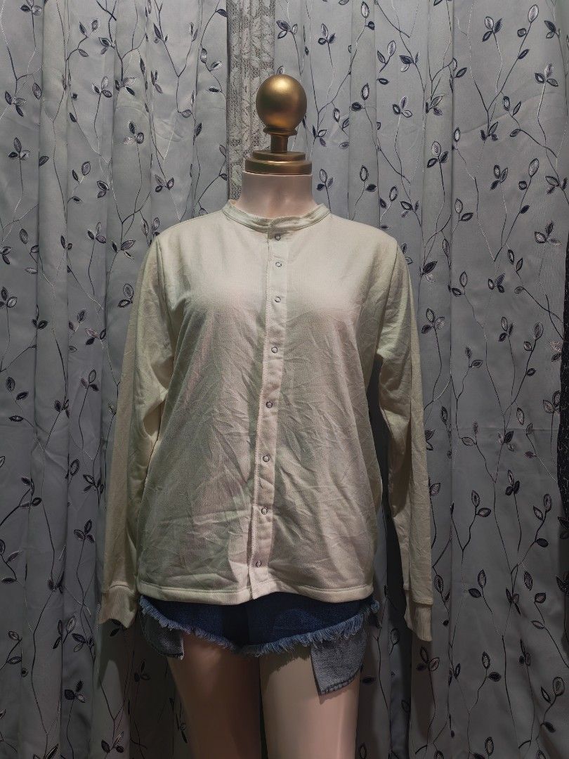 Cream Long Sleeve Button Cardigan Top (Category: Coats, Jackets and Outerwear) located in Caloocan City. Submitted by _misskaye (Listing ID 1467605230, Image 3). Description: - Color: Cream - Material: Ribbed knit - Details: Front snap buttons, round neckline, fitted cuffs - Style: Casual, easy to pair with denim shorts or jeans - Condition: Excellent.