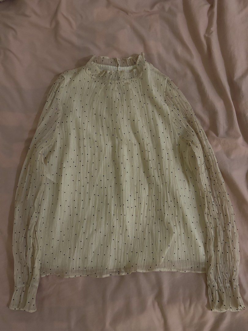 Cream polka dot ruffled long sleeve blouse (Category: Blouses) located in Quezon City. Submitted by bae.randa (Listing ID 1467627167, Image 2). Description: - Cream-colored blouse with tiny black polka dots - Lightweight crinkled fabric with fully lined body - High ruffled collar and back keyhole button closure - Long sleeves with trendy flared cuffs .
