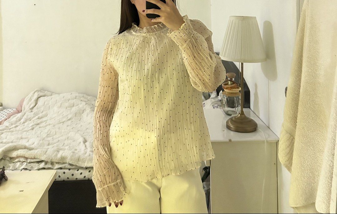 Cream polka dot ruffled long sleeve blouse (Category: Blouses) located in Quezon City. Submitted by bae.randa (Listing ID 1467627167, Image 1). Description: - Cream-colored blouse with tiny black polka dots - Lightweight crinkled fabric with fully lined body - High ruffled collar and back keyhole button closure - Long sleeves with trendy flared cuffs .