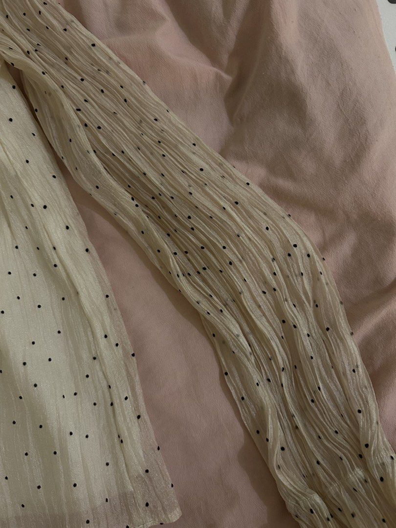 Cream polka dot ruffled long sleeve blouse (Category: Blouses) located in Quezon City. Submitted by bae.randa (Listing ID 1467627167, Image 3). Description: - Cream-colored blouse with tiny black polka dots - Lightweight crinkled fabric with fully lined body - High ruffled collar and back keyhole button closure - Long sleeves with trendy flared cuffs .