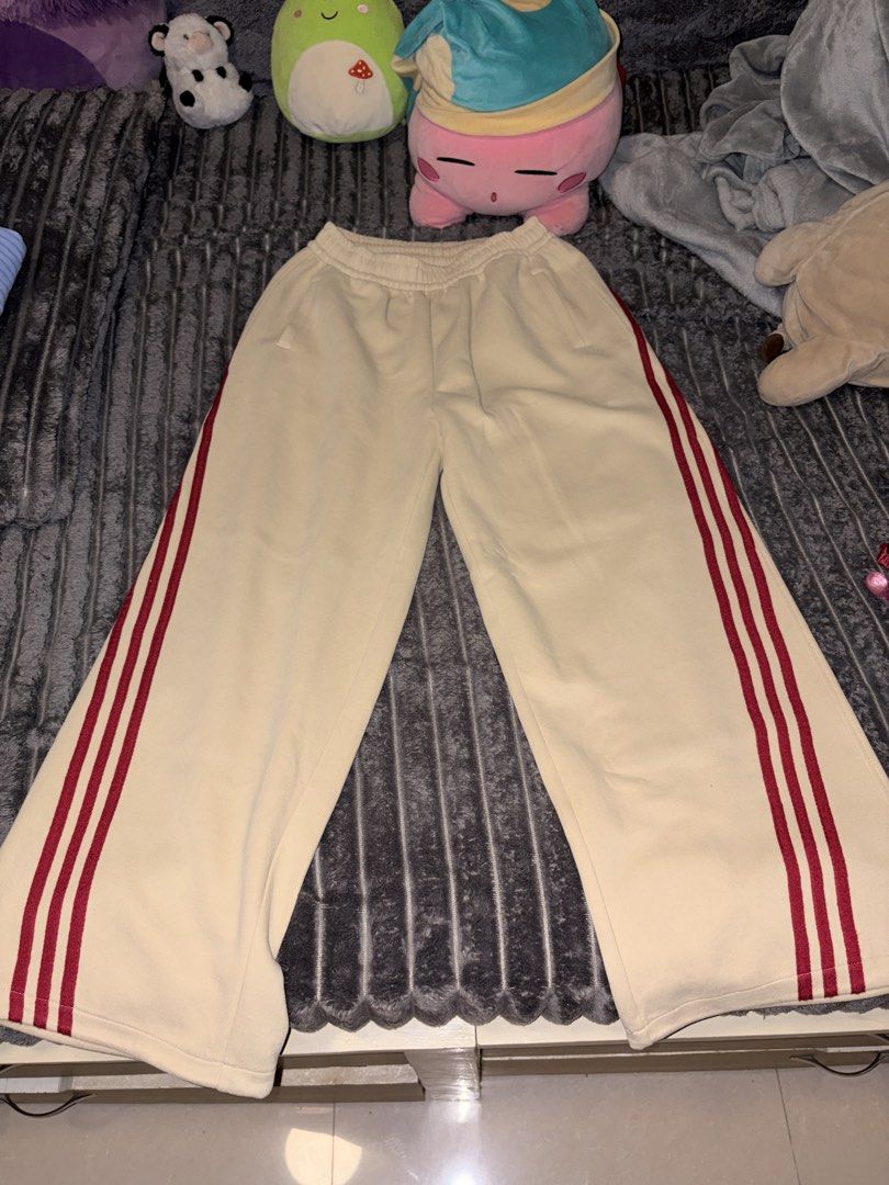 Cream Sweatpants with Red Side Stripes (Category: Other Bottoms) located in Manila. Submitted by so.soiaa (Listing ID 1467682669, Image 1). Description: - Color: Cream with bright red side stripes - Fit: Relaxed wide-leg - Waistband: Elastic with adjustable drawstring - Pockets: Two front pockets - Material: Super soft and cozy - Style: Easy to dress up or down for casual days.