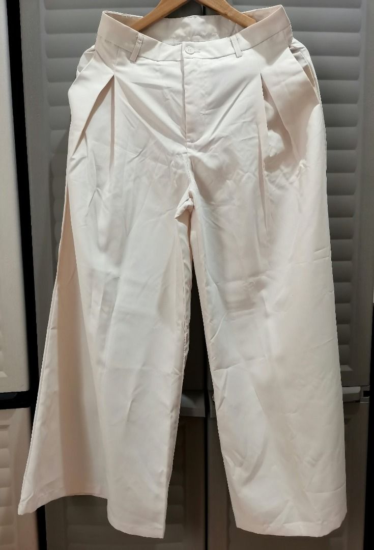 Cream wide leg trousers (Category: Jeans) located in Manila. Submitted by mahanaim.67c328 (Listing ID 1467759981, Image 2). Description: - Size: M - Color: Cream - Material: 100% polyester - Design: Pleated front with zipper fly and button closure - Style: Versatile for casual or formal wear .