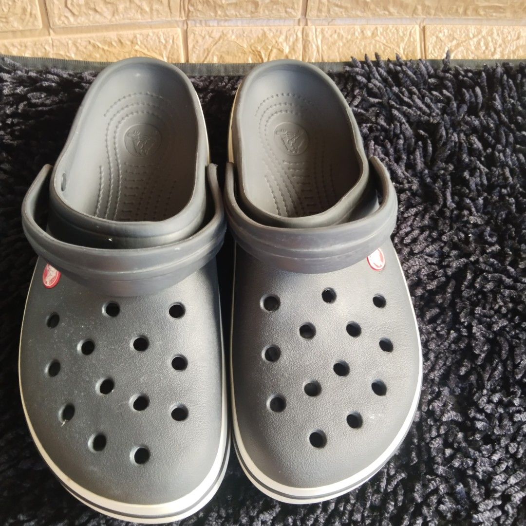 Crocs Classic Clog Grey with White Midstripe (Category: Slippers & Slides) located in Lubao. Submitted by dione_closet503 (Listing ID 1467633687, Image 1). Description: - Color: Grey with a contrasting white stripe around the sole - Material: Waterproof and super easy to clean - Comfort: Classic ventilation holes for breathability and a textured footbed for extra grip - Versatile: Features an adjustable heel strap that can be worn forward or back