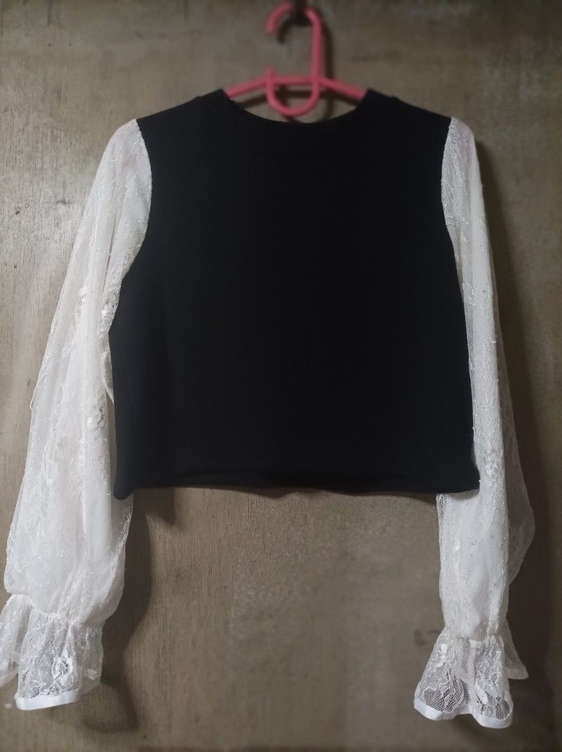 CROPPED BLOUSE (Category: Blouses) located in Makati City. Submitted by jessu_ (Listing ID 1467644295, Image 1). Description: Black cropped top with sheer white lace sleeves and ruffle cuffs. Lightweight knit texture, perfect for pairing with high-waisted bottoms. Small to medium 2nd photo for closer look Buy 3 + 1 free of your choice from any available listing RFS: Decluttering MOP: GCash or bank transfer.