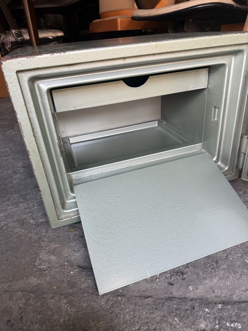 Crown Steel Security Safe with Combination Lock (Category: Safe) located in Quezon City. Submitted by mikesiawingco (Listing ID 1467672815, Image 3). Description: - Brand: Crown - Color: Classic Green - Material: Heavy-duty metal construction for maximum security - Lock Type: Rotary combination dial (code included on tape for easy access) - Interior: Includes a convenient sliding metal storage tray - Dimensions: Approx. 19" Length x 15.5" Width x