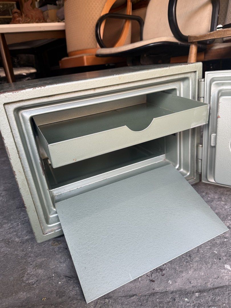 Crown Steel Security Safe with Combination Lock (Category: Safe) located in Quezon City. Submitted by mikesiawingco (Listing ID 1467672815, Image 2). Description: - Brand: Crown - Color: Classic Green - Material: Heavy-duty metal construction for maximum security - Lock Type: Rotary combination dial (code included on tape for easy access) - Interior: Includes a convenient sliding metal storage tray - Dimensions: Approx. 19" Length x 15.5" Width x