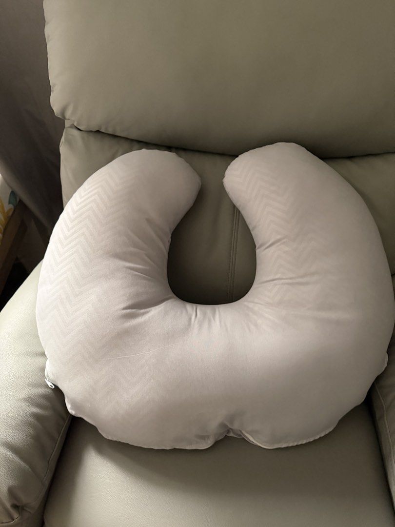 C-shaped nursing pillow with grey chevron pattern (Category: Maternity Care) located in Guiguinto. Submitted by eneyech (Listing ID 1467711530, Image 2). Description: - Colour/Pattern: Grey with all-over chevron pattern - Design: Curved C-shape for optimal feeding support - Cover: Removable with zip closure for easy washing - Material: Soft fabric texture - Condition: Clean and well-maintained.