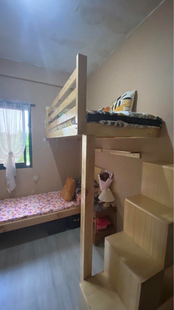 Custom L-Shaped Wooden Loft Bed with Stairs (Category: Bed Frames & Mattresses) located in Taguig. Submitted by k.nvjs (Listing ID 1467409302, Image 2). Description: Custom wooden loft bed in natural finish with a lower single bed, right-side built-in staircase, and upper safety rails. Perfect space-saving solution for kids or guest rooms. Dimensions: 167 cm top width, 187 cm lower length, 146 cm lower height..