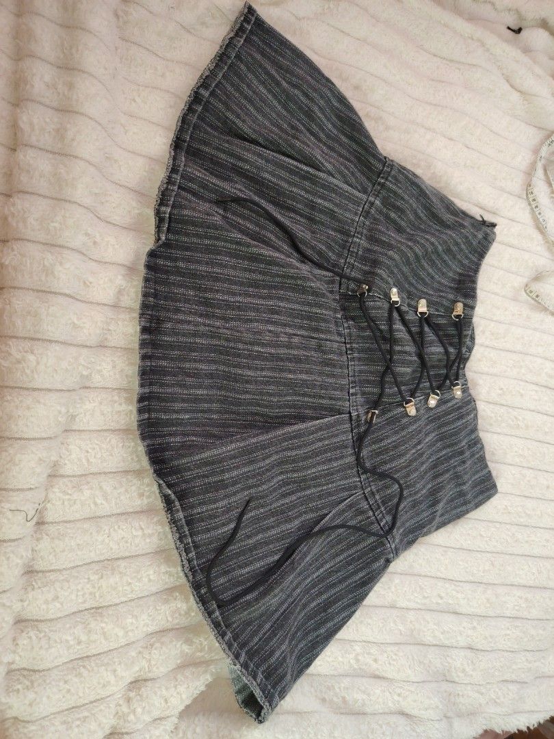 Dark Grey Pinstripe Laced Mini Skirt (Category: Skirts) located in Mabalacat. Submitted by Jackikay.PreLoved (Listing ID 1467619232, Image 2). Description: - Color: Dark grey with white pinstripes - Style: Y2K alternative, flared hem with slight raw edge - Details: Front lace-up black cord with silver-tone eyelets - Closure & Lining: Convenient side zipper and comfortable black inner lining - Styling: Pairs amazingly with boots or platform shoes 