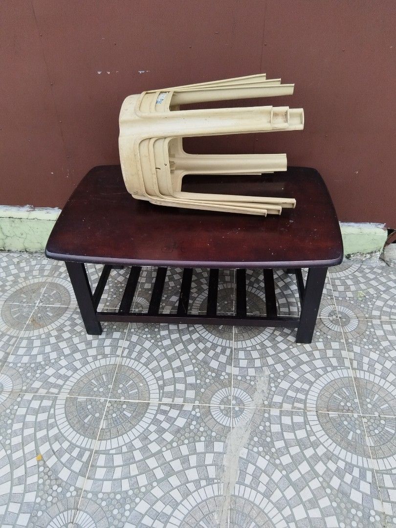 Dark Wood Coffee Table with Storage Shelf (Category: Tables & Sets) located in Quezon City. Submitted by nickylopez37770 (Listing ID 1467604146, Image 1). Description: - Dark brown wooden coffee table - Features a spacious rectangular top and a lower slatted shelf for magazines or baskets - Sturdy wooden frame and legs - Dimensions: Approximately 38 inches long - Condition: Shows normal surface wear and scratches on the top from previous use.