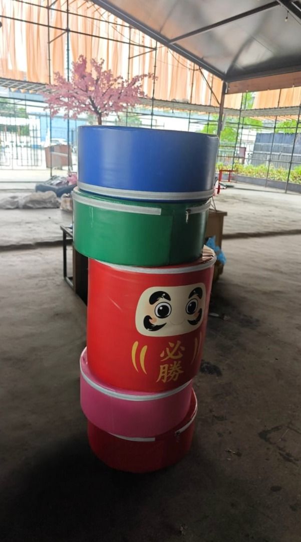 Daruma Stackable round storage containers (Category: Food Organisation & Storage) located in Kuala Lumpur. Submitted by lumikim (Listing ID 1467648367, Image 1). Description: Stack of five round cylindrical storage containers in blue, green, red, and pink. One red container features a Japanese Daruma doll face graphic with Japanese text. Zippered closures on each piece. Durable synthetic fabric construction. Useful for organizing gear, toys, or s