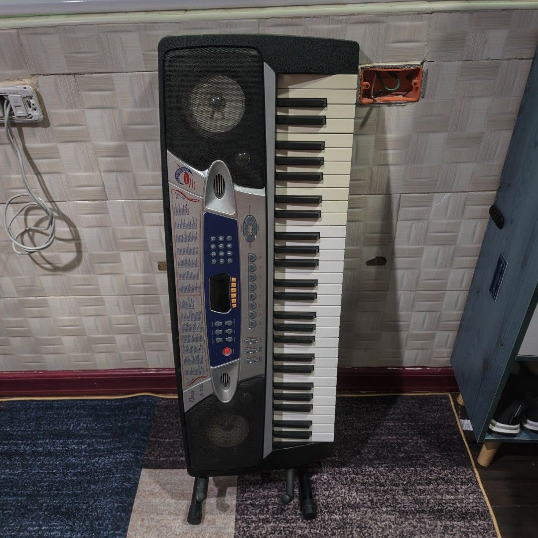Davis D-108 54-Key Electronic Keyboard (Category: Musical Instruments) located in Manila. Submitted by queenofthesea0202 (Listing ID 1467644985, Image 1). Description: - Model: Davis D-108 Electronic Keyboard - Keyboard: 54 keys with built-in speakers and LED display - Sounds & Rhythms: 100 timbres, 100 rhythms, and 8 demo songs - Power Options: Runs on 6 D batteries or DC 9V power supply - Inclusions: Keyboard stand included - Condition: Great f