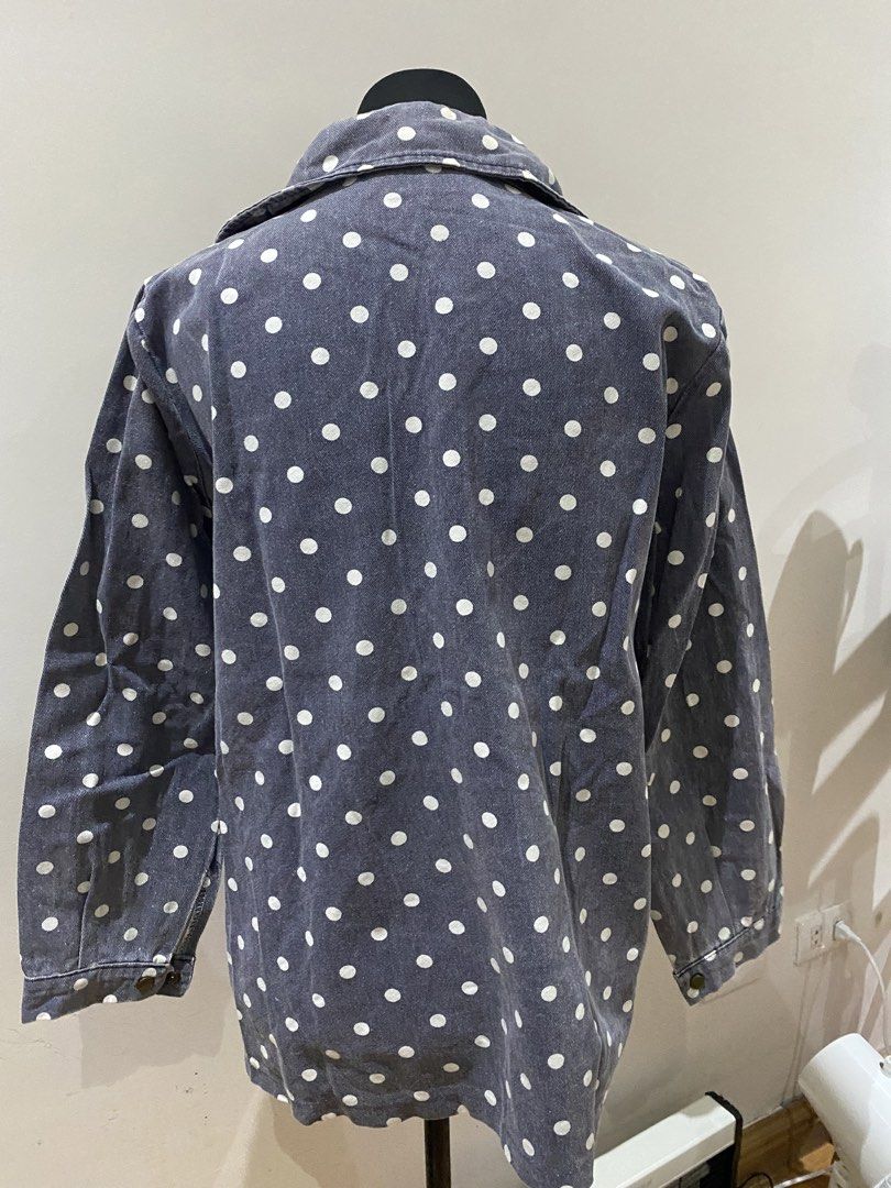 Denim jacket polka dot with floral embroidery (Category: Coats, Jackets and Outerwear) located in Manila. Submitted by mpt99876 (Listing ID 1467796413, Image 2). Description: - Style: Grey denim button-up shirt or lightweight jacket - Pattern: All-over white polka dots with floral embroidery near the hem - Pockets: Two chest pockets with button flaps - Sleeves: Long sleeves with button cuffs - Fit: Comfortable relaxed fit with a classic collared 