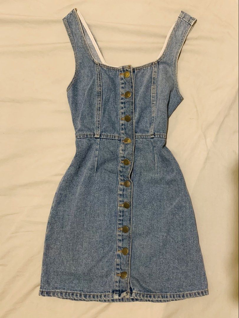 Denim mini dress with front buttons (Category: Dresses) located in Manila. Submitted by coquettecore (Listing ID 1467772851, Image 1). Description: Light wash denim mini dress, sleeveless style with a scoop neckline. Full front button closure down the center with brass hardware. Size: Small-Medium No issue Lightly Use.