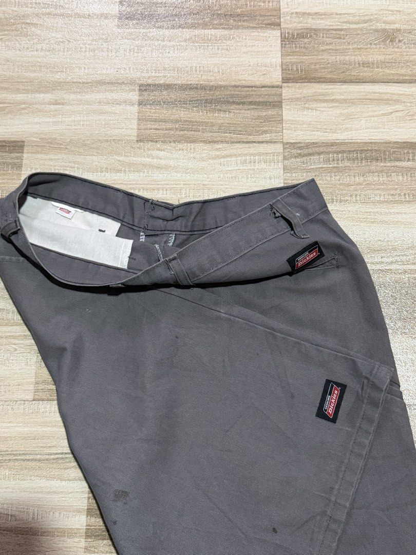 Dickies Double Patch (Category: Shorts) located in Manila. Submitted by totoygolem69 (Listing ID 1467613651, Image 3). Description: - Brand: Genuine Dickies - Color: Dark Grey - Style: Classic skate / workwear cargo shorts - Features: Multiple utility pockets, standard zip fly, button closure, and branded woven logo patches - Material: Durable cotton blend - Condition: Minor wear and faint spotting across the fabric, plenty of life left.