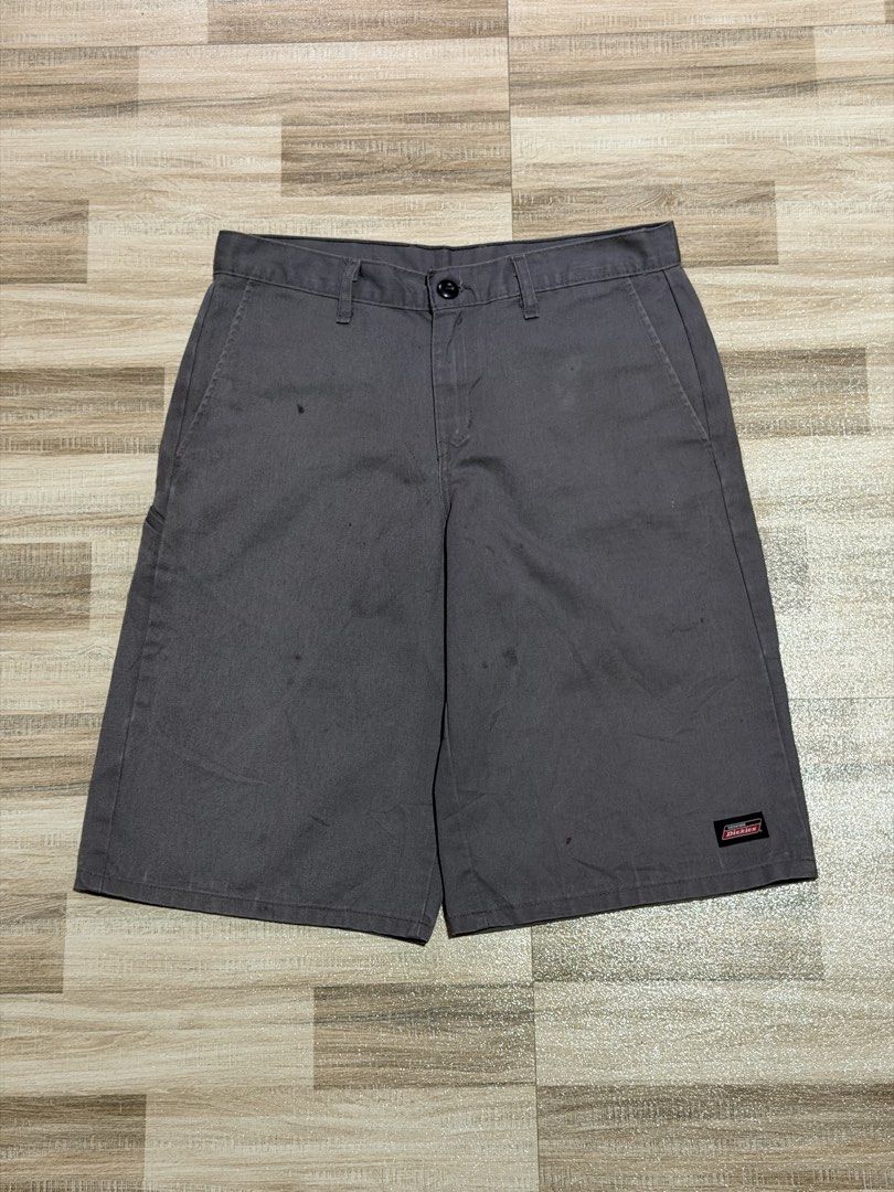 Dickies Double Patch (Category: Shorts) located in Manila. Submitted by totoygolem69 (Listing ID 1467613651, Image 1). Description: - Brand: Genuine Dickies - Color: Dark Grey - Style: Classic skate / workwear cargo shorts - Features: Multiple utility pockets, standard zip fly, button closure, and branded woven logo patches - Material: Durable cotton blend - Condition: Minor wear and faint spotting across the fabric, plenty of life left.