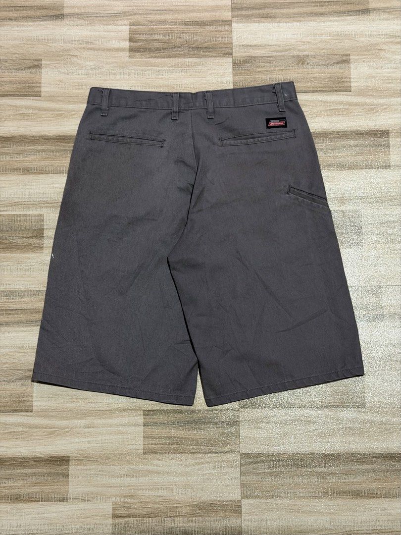 Dickies Double Patch (Category: Shorts) located in Manila. Submitted by totoygolem69 (Listing ID 1467613651, Image 2). Description: - Brand: Genuine Dickies - Color: Dark Grey - Style: Classic skate / workwear cargo shorts - Features: Multiple utility pockets, standard zip fly, button closure, and branded woven logo patches - Material: Durable cotton blend - Condition: Minor wear and faint spotting across the fabric, plenty of life left.