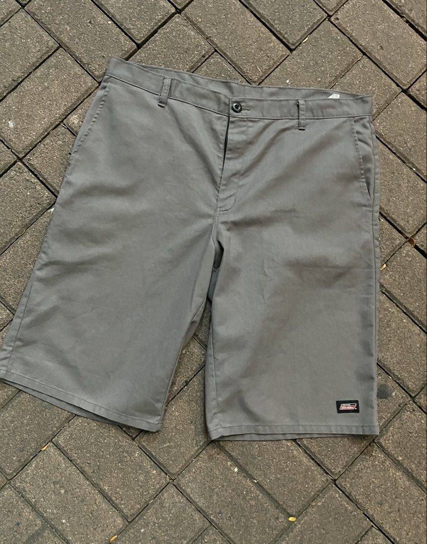 Dickies Grey Work Shorts (Category: Shorts) located in Manila. Submitted by rusell_inmotion (Listing ID 1467825045, Image 1). Description: Dickies grey work shorts in a solid neutral shade. Multiple pockets including side utility pocket and button closure. Durable fabric holds up well for everyday wear or skate sessions. Dickies logo patch stitched near the hem and back pocket. Standard belt loops included..