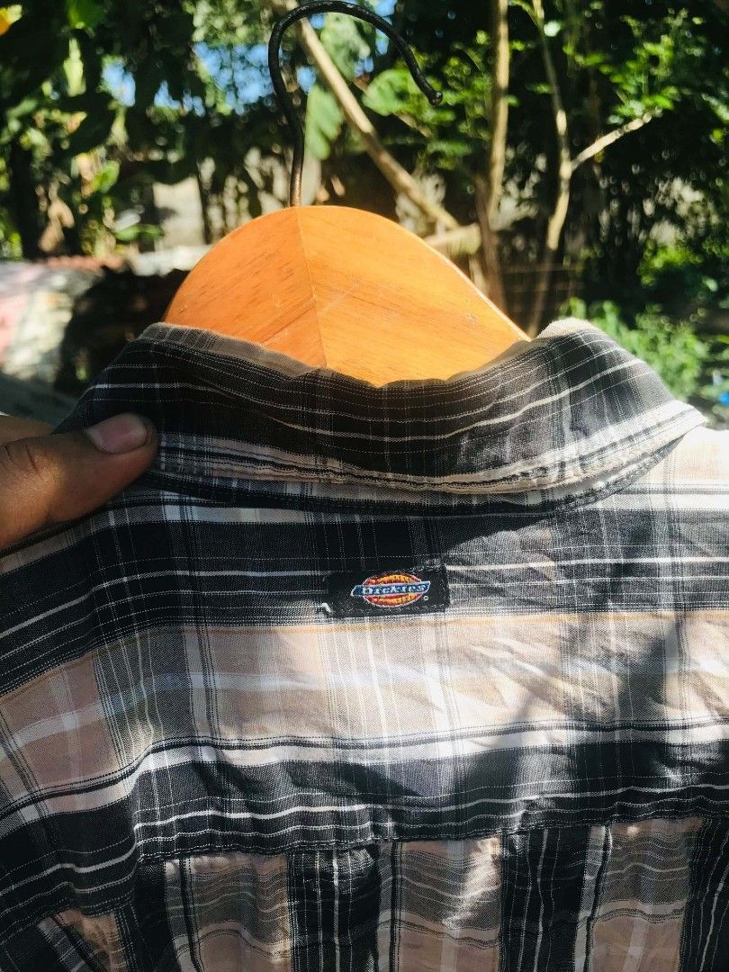 Dickies plaid short sleeve button up shirt medium (Category: Tshirts & Polo Shirts ) located in Camiling. Submitted by lester_jan (Listing ID 1467654670, Image 2). Description: - Brand: Dickies - Style: Short sleeve button-down shirt - Pattern: Black, beige, and white plaid - Size: Medium (M) - Material: 100% cotton - Features: Classic collar, front button closure, single chest pocket with logo tag - Condition: Excellent, ready to wear.