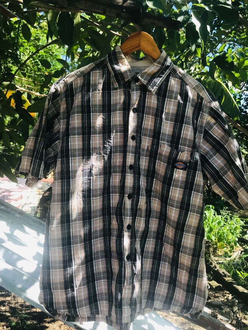 Dickies plaid short sleeve button up shirt medium (Category: Tshirts & Polo Shirts ) located in Camiling. Submitted by lester_jan (Listing ID 1467654670, Image 1). Description: - Brand: Dickies - Style: Short sleeve button-down shirt - Pattern: Black, beige, and white plaid - Size: Medium (M) - Material: 100% cotton - Features: Classic collar, front button closure, single chest pocket with logo tag - Condition: Excellent, ready to wear.