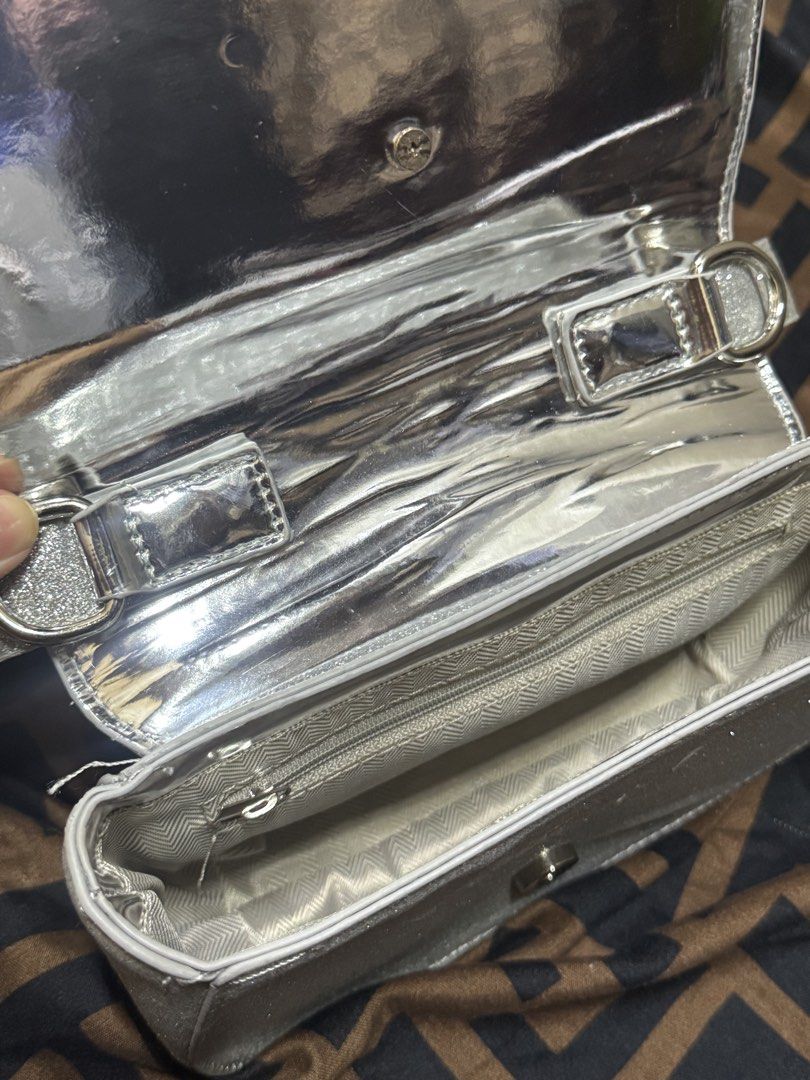 Diesel Silver Glitter Shoulder Bag Crossbody (Category: Cross-body Bags) located in Manila. Submitted by angelovesbuldak (Listing ID 1467797462, Image 3). Description: - Sparkly silver glitter exterior with iconic gold oval Diesel logo - Shiny silver metallic interior lining - Clean, structured shape with a fixed handle - Includes an extra detachable strap (brand new, still wrapped in plastic) - Practical interior with multiple compartments and a