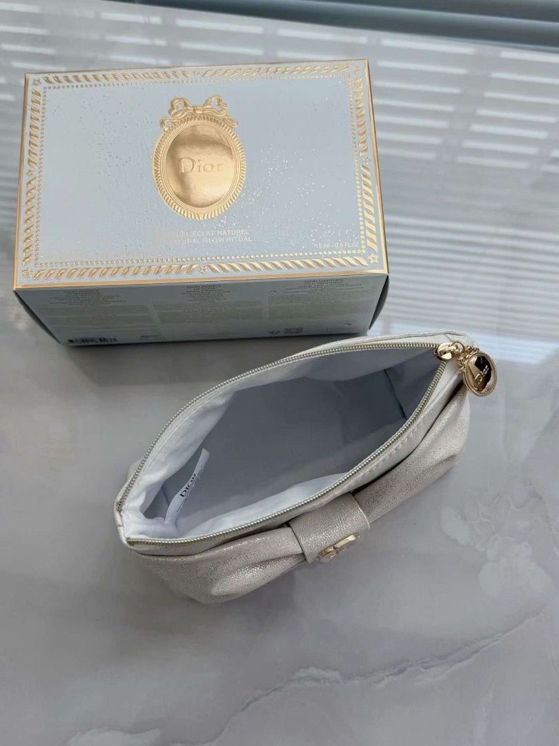 Dior Makeup Pouch Vanity Medallion 2026 (Category: Purses & Pouches) located in Makati City. Submitted by mariaasevilla0622eb (Listing ID 1467762090, Image 3). Description: - Authentic Dior cosmetic bag in a gorgeous shimmery beige shade - Features a chic large front bow accented with gold-tone CD logo hardware - Includes a round Dior zipper pull and a matching detachable star charm keychain - Clean interior lining complete with the official Dior
