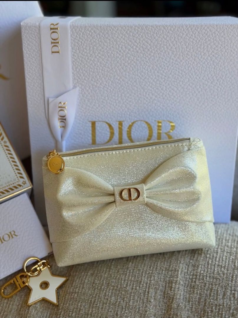 Dior Makeup Pouch Vanity Medallion 2026 (Category: Purses & Pouches) located in Makati City. Submitted by mariaasevilla0622eb (Listing ID 1467762090, Image 1). Description: - Authentic Dior cosmetic bag in a gorgeous shimmery beige shade - Features a chic large front bow accented with gold-tone CD logo hardware - Includes a round Dior zipper pull and a matching detachable star charm keychain - Clean interior lining complete with the official Dior