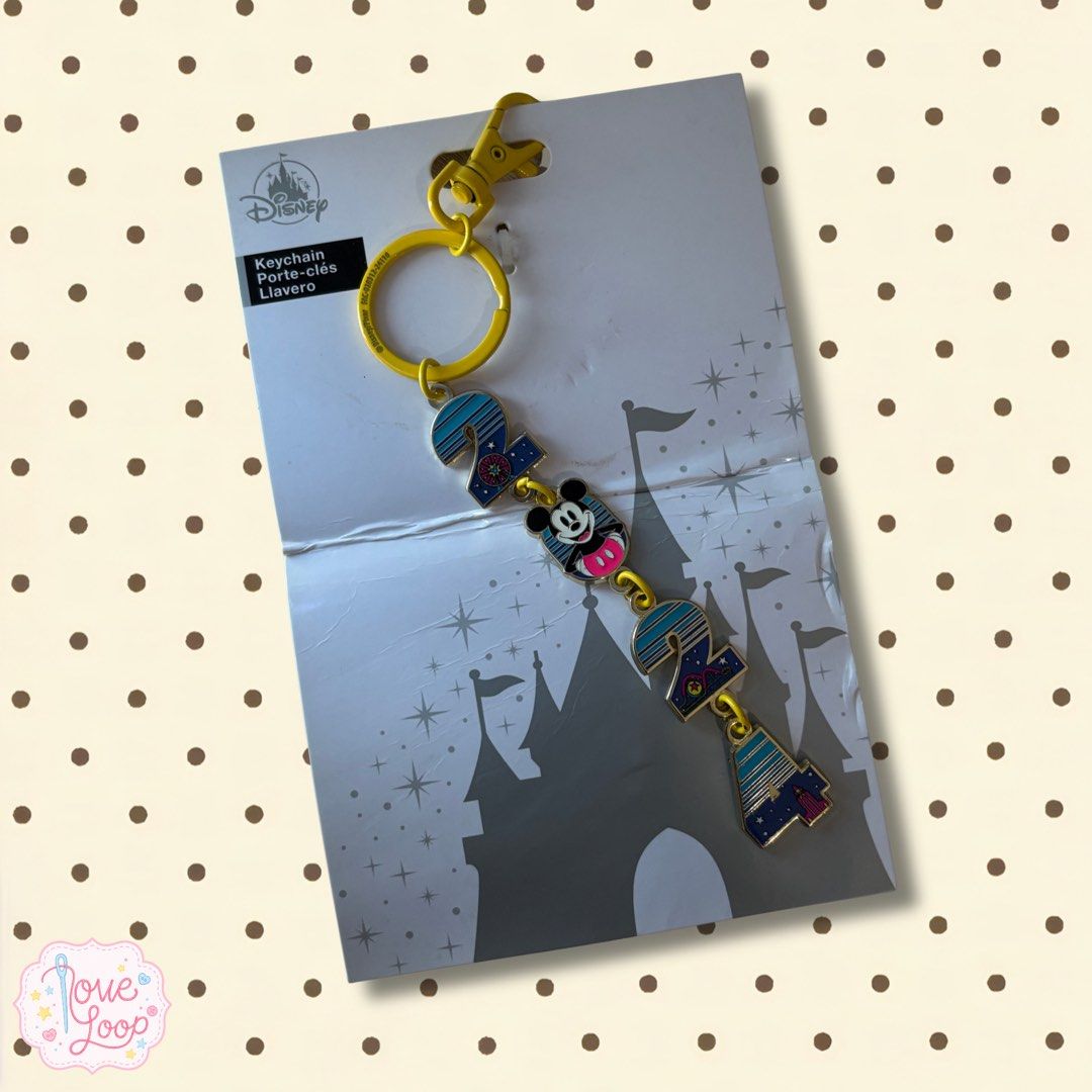 Disney 2024 Mickey Mouse Castle Keychain (Category: Character Goods) located in Manila. Submitted by love.loop (Listing ID 1467706899, Image 1). Description: - Official Disney 2024 commemorative keychain - Features a cute Mickey Mouse icon right in the middle - Blue striped design with magical castle and star graphics - Equipped with vibrant yellow hardware, lobster clasp, and split ring - Brand new, never removed from original cardboard backing 