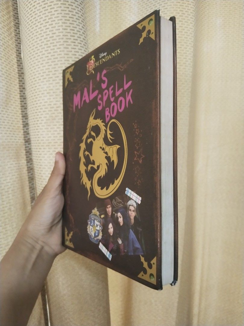 Disney Descendants Mal's Spell Book Bundle (Category: Children's Books) located in Cavite. Submitted by munting_aklatan_ph (Listing ID 1467653124, Image 3). Description: - Item: Bundle Disney Descendants Mal's Spell Book and Spell Book II (Hardback) - Condition: Clean pages inside with a solid spine, corner cover with minor fraying due to storage - Features: Filled with notes, spells, and doodles from your favorite VKs - Ideal for: Fans of the Di