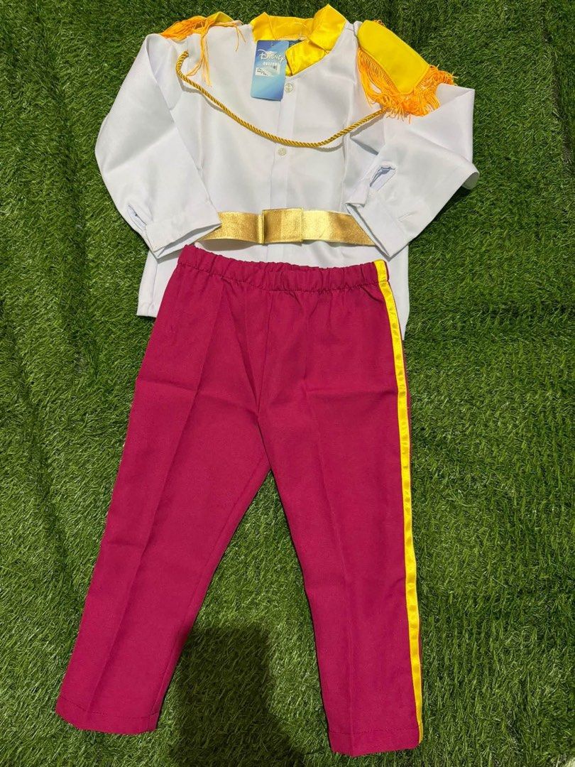 Disney Prince Charming Costume Set (Category: Babies & Kids Fashion) located in San Fernando. Submitted by InvisibleMe (Listing ID 1467669438, Image 1). Description: - Brand new with tags Disney Prince Charming costume set - Includes white long-sleeve shirt featuring yellow epaulettes, gold trim, and attached belt - Includes deep pink pants with matching yellow side stripes - Ideal for Halloween, birthday parties, and dress-up events.