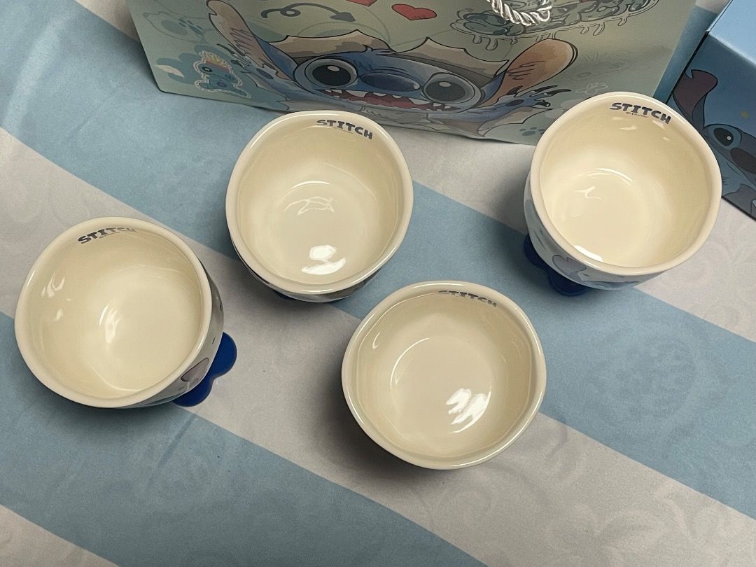 Disney Stitch Ceramic Goblet Cups Set with Box and Bag (Category: Coffee & Tea Tableware) located in Subic. Submitted by anything_lovely_under_the_sun (Listing ID 1467758326, Image 3). Description: - Set of 4 adorable Disney Stitch ceramic goblet cups - Features cute Stitch graphics and a stylish blue flower base - Comes with individual blue packaging boxes and a matching Stitch paper gift bag - Perfect for Disney fans or everyday use - Clean con