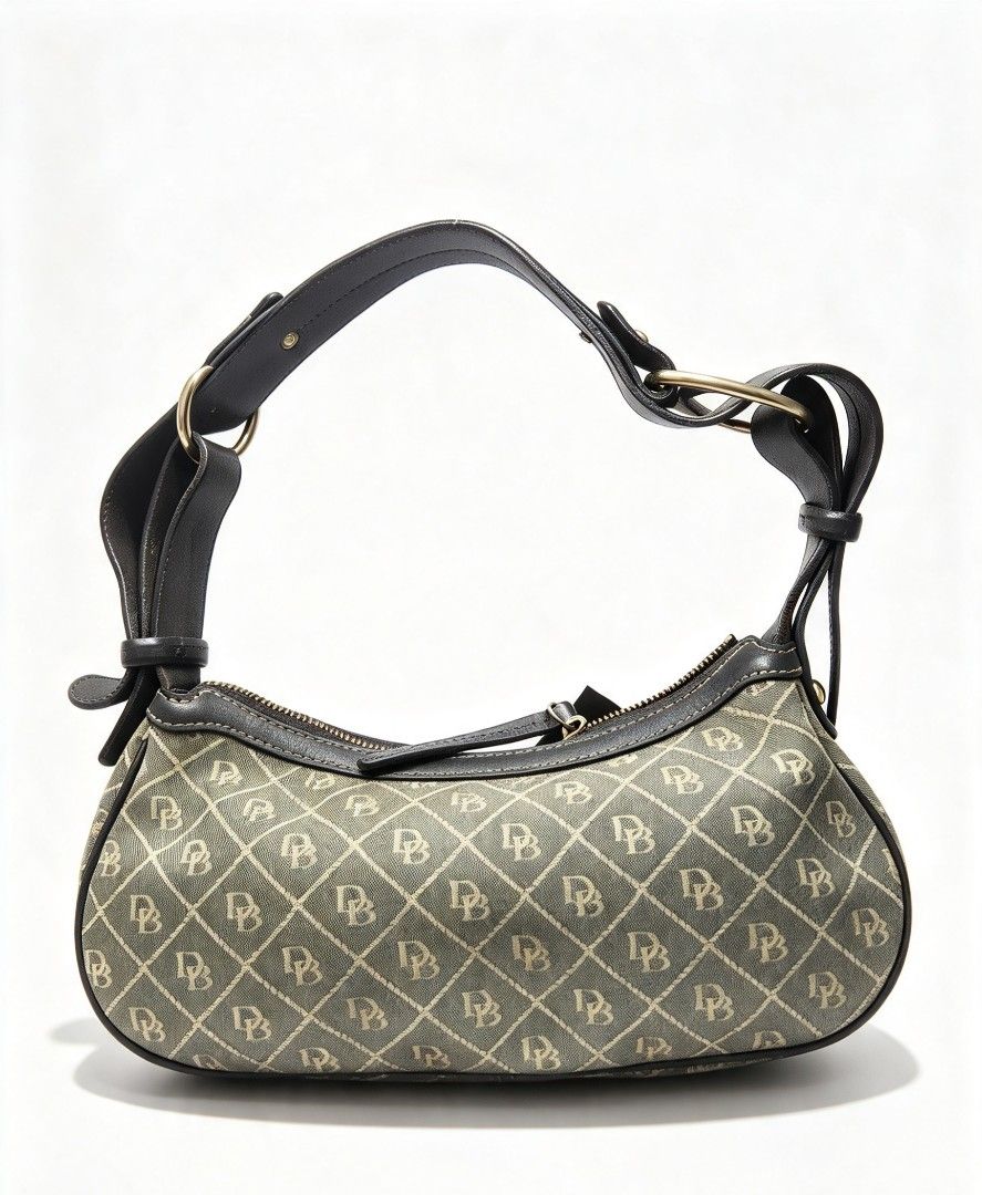 Dooney & Bourke Monogram Shoulder Bag with Front Zippers (Category: Luxury Bags & Wallets) located in Manila. Submitted by jialyn03310_tree (Listing ID 1467832972, Image 2). Description: Grey canvas shoulder bag featuring an all-over monogram pattern, black leather trim, and contrast white stitching. Includes two front zipper pockets, silver-tone hardware, and a secure top zip closure. Clean interior..