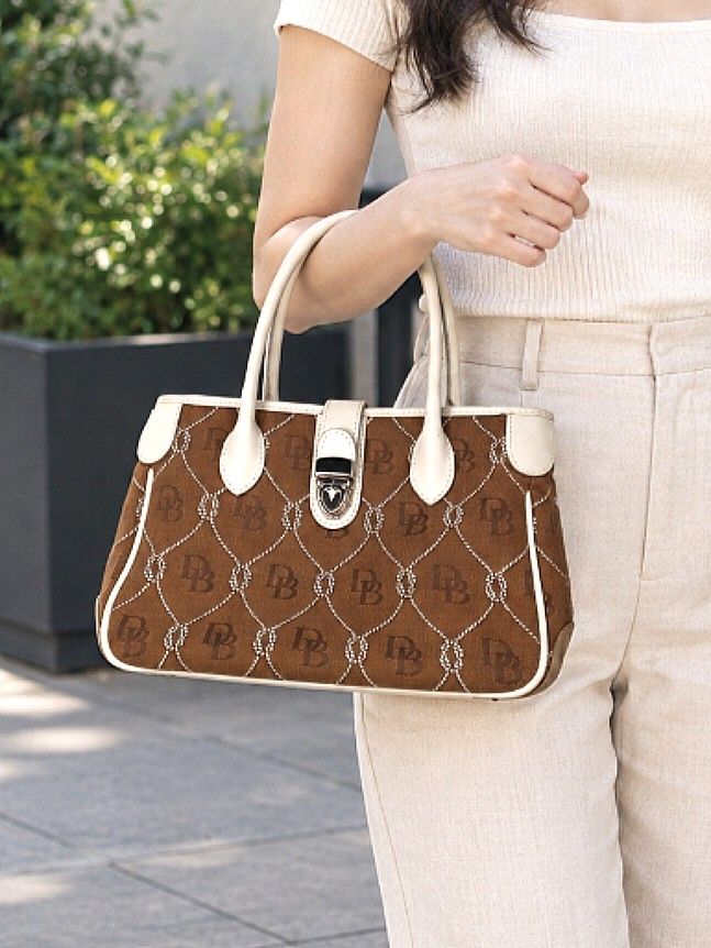 AUTHENTIC DOONEY & BOURKE MONOGRAM SEMI - MEDIUM TOTE BAG BROWN WHITE (Category: Luxury Bags & Wallets) located in Quezon City. Submitted by sparkys.joy_88 (Listing ID 1467716339, Image 2). Description: - Authentic Dooney & Bourke brown and white monogram handbag - Stylish rope lattice design with durable white leather trim and dual handles - Nice and classic color wear - Secure silver-tone hardware with classic lock closure - Structured bottom e