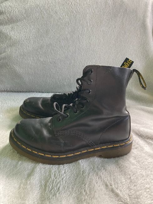 Dr. Martens Pascal Black Leather Boots (Category: Boots) located in Rizal. Submitted by sheeraay (Listing ID 1467708925, Image 2). Description: - Brand: Dr. Martens - Style: Classic 8-eyelet lace-up boots - Color: Black leather with iconic yellow welt stitching and heel loops - Condition: Pre-loved with visible scuffs on the toe area and moderate wear on soles - Longevity: Well-maintained and still has plenty of life left for daily wear.