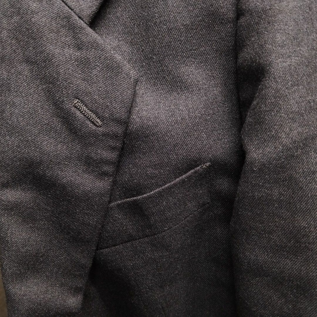 D'Urban Dark Grey Suit Jacket Blazer (Category: Coats, Jackets and Outerwear) located in Pasig City. Submitted by kat_grande (Listing ID 1467652742, Image 3). Description: Dark grey blazer from D'Urban. Two-button closure, notched lapels, flap pockets at the front. Fully lined interior with branded label patch. Four-button detail on cuffs. Structured fit through the shoulders. Classic neutral tone goes with plenty of outfits. Clean condition over