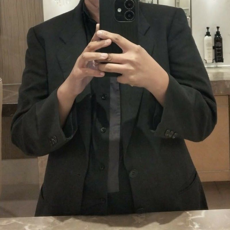 D'Urban Dark Grey Suit Jacket Blazer (Category: Coats, Jackets and Outerwear) located in Pasig City. Submitted by kat_grande (Listing ID 1467652742, Image 2). Description: Dark grey blazer from D'Urban. Two-button closure, notched lapels, flap pockets at the front. Fully lined interior with branded label patch. Four-button detail on cuffs. Structured fit through the shoulders. Classic neutral tone goes with plenty of outfits. Clean condition over